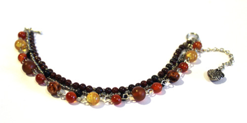 A beautiful bracelet, made with carnelian, ruby bracciated jasper, horn, and czech glass seedbeads